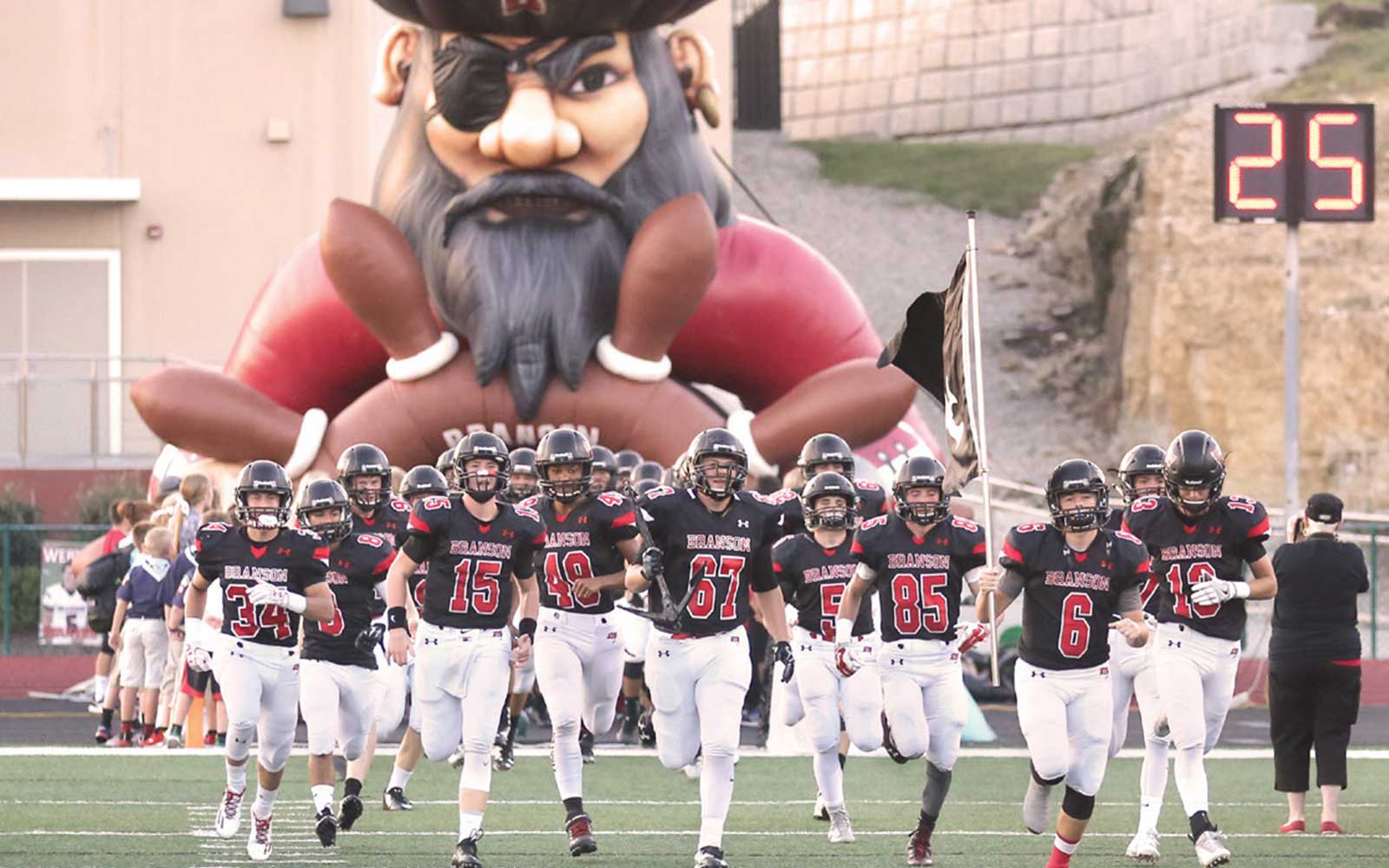 Branson High School football team runs to takes the field